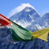 most dangerous places to travel in africa Prayer Flags With mountain backdrop Nepal